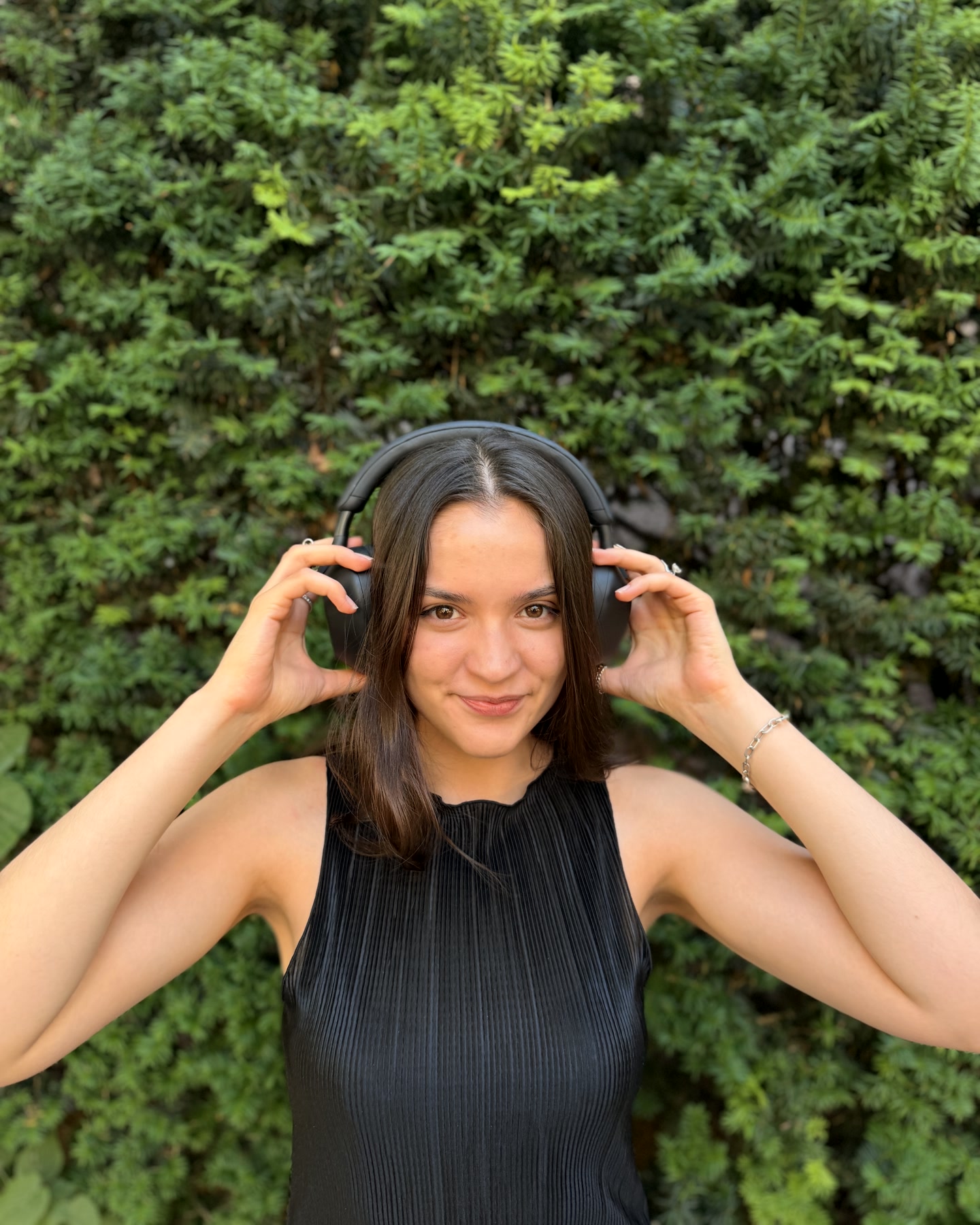 A woman with headphones, calm before a SYLO session